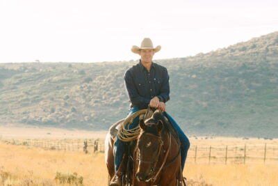 man on a horse with southern utah rural background